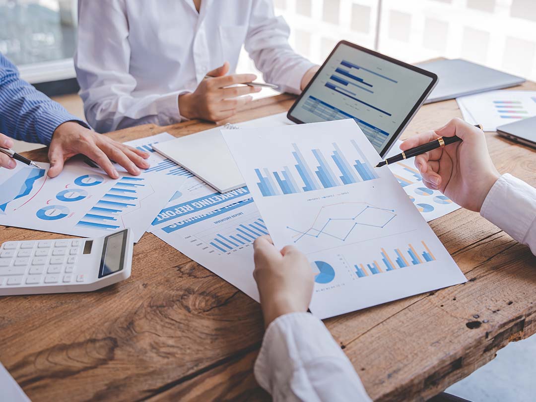 Colleagues in office looking at charts on a table